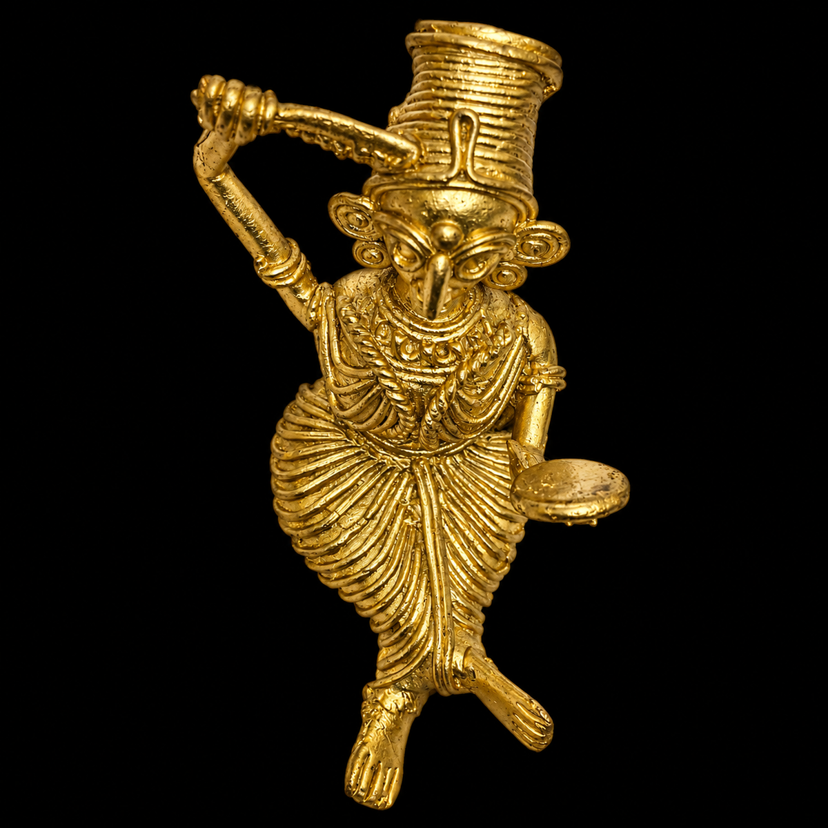 A small Dokra figurine of a stylized sitting female figure with a mirror in one hand and comb in the other, shown against a solid black background.