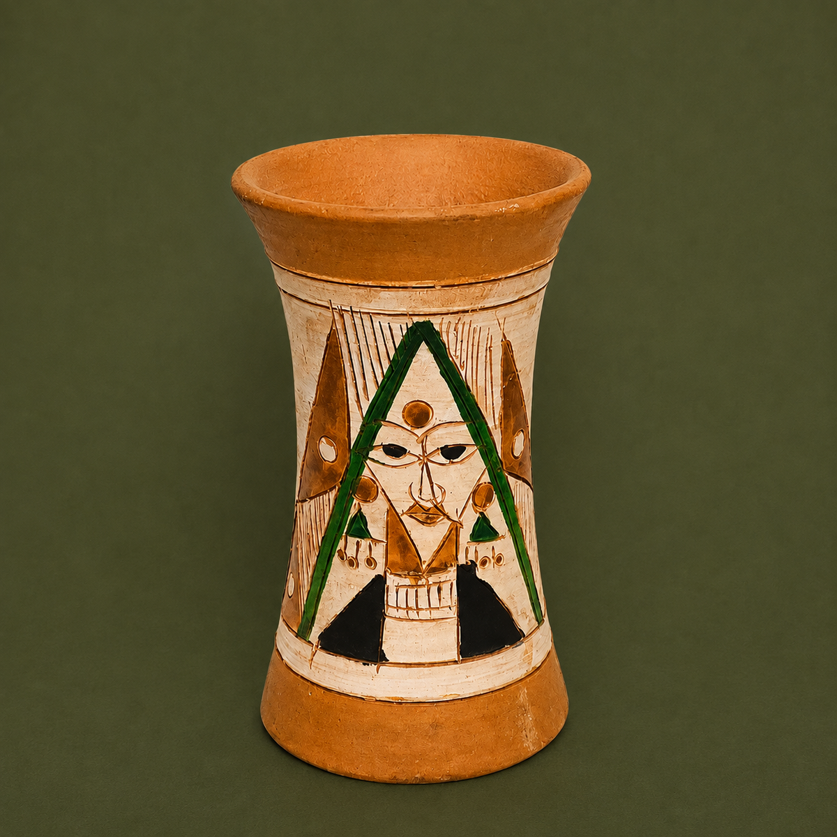 A handmade terracotta vase with hand-painted geometric and tribal-style motifs, set against a solid dark olive green background.