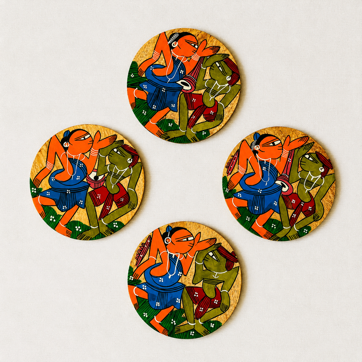 Four round wooden coasters featuring traditional Indian Patachitra art illustration of tribal figures, displayed on a light beige background.